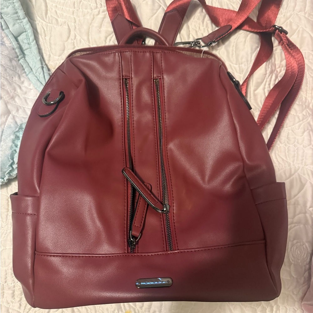 Cluci Burgundy Backpack with Zipper Accents multiple pockets inside . Like new.